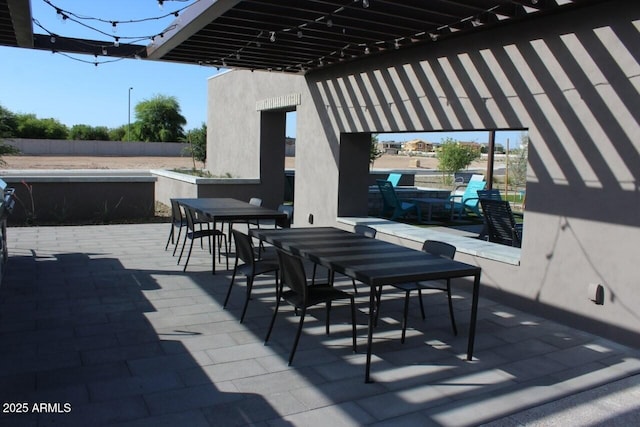 view of patio / terrace featuring outdoor dining area and fence