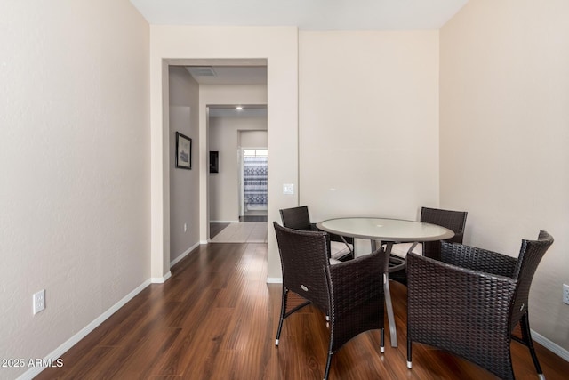 dining area featuring dark hardwood / wood-style floors