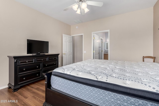 bedroom featuring dark hardwood / wood-style flooring, connected bathroom, and ceiling fan