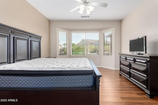 bedroom with dark hardwood / wood-style floors and ceiling fan