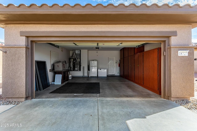 garage with white refrigerator and heating unit