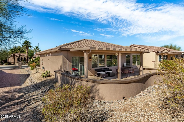 rear view of house featuring outdoor lounge area and a patio