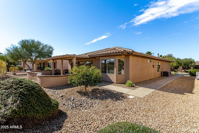 view of side of home with central AC unit and a patio area