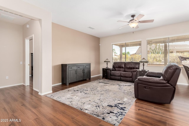 living room featuring dark hardwood / wood-style flooring and ceiling fan