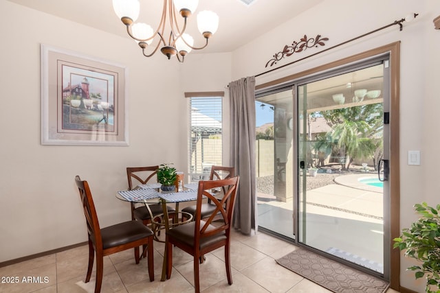 tiled dining space with a chandelier