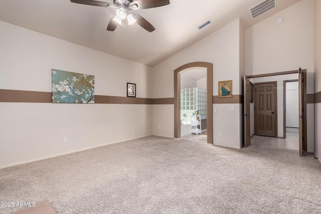 carpeted empty room with ceiling fan and lofted ceiling