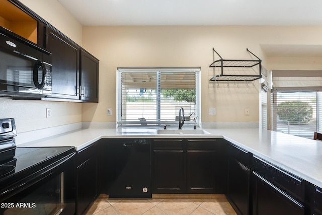 kitchen featuring light tile patterned floors, sink, and black appliances