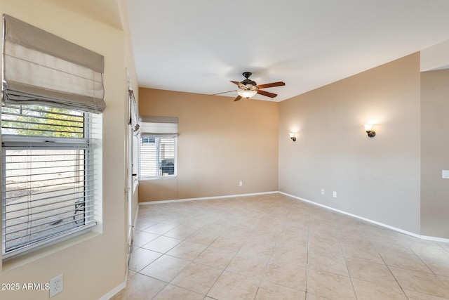 tiled spare room featuring ceiling fan