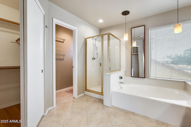 bathroom with plenty of natural light, plus walk in shower, and tile patterned flooring