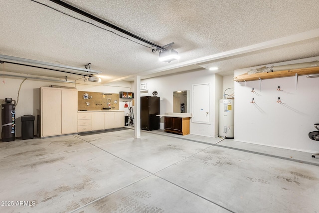 garage featuring a garage door opener, electric water heater, and black refrigerator