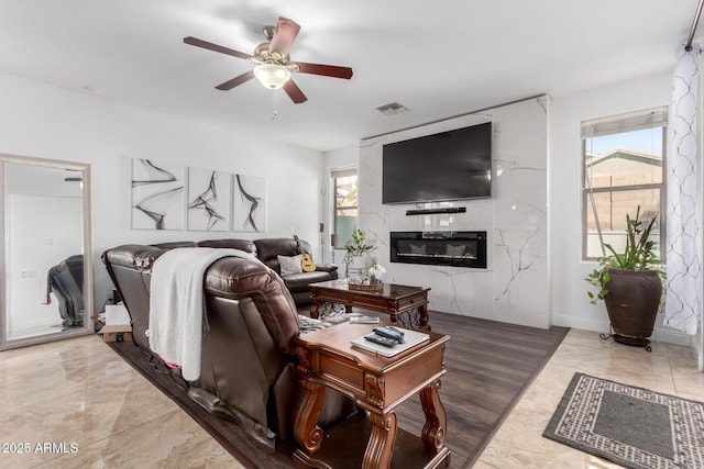 living room with plenty of natural light and ceiling fan