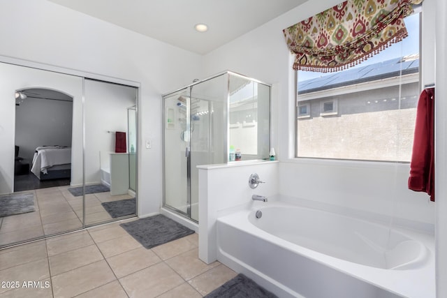 bathroom with tile patterned floors and plus walk in shower