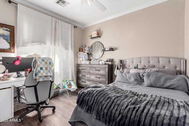 bedroom with ornamental molding and light hardwood / wood-style floors