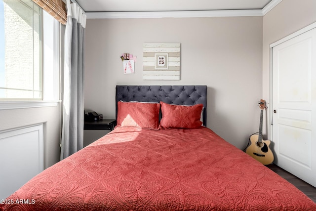 bedroom featuring ornamental molding and hardwood / wood-style floors