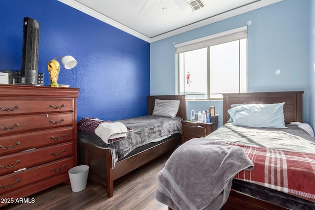 bedroom featuring ornamental molding, ceiling fan, and dark hardwood / wood-style flooring