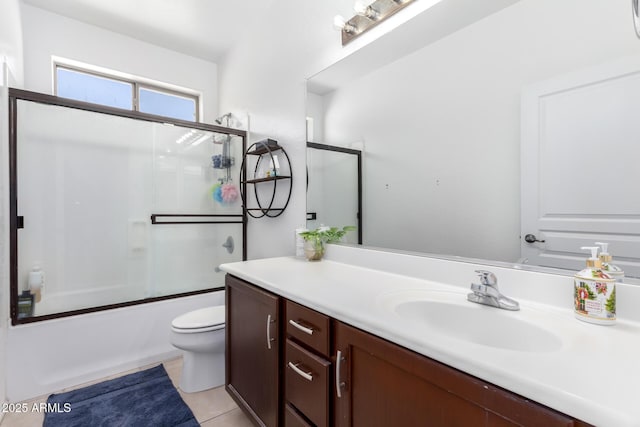 full bathroom featuring vanity, tile patterned flooring, enclosed tub / shower combo, and toilet