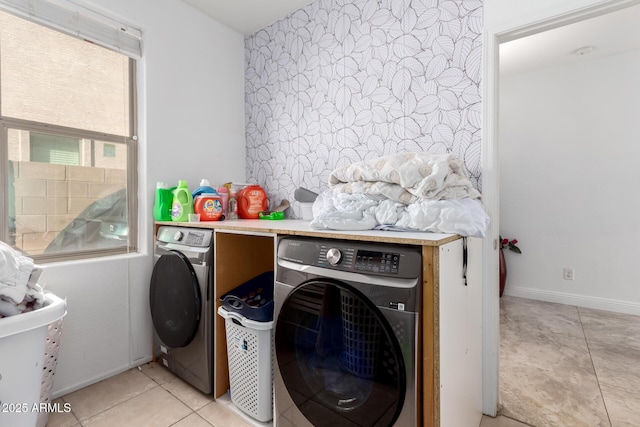 laundry area with light tile patterned floors and independent washer and dryer