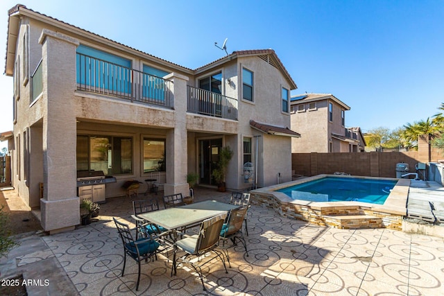 view of pool with a patio and an in ground hot tub