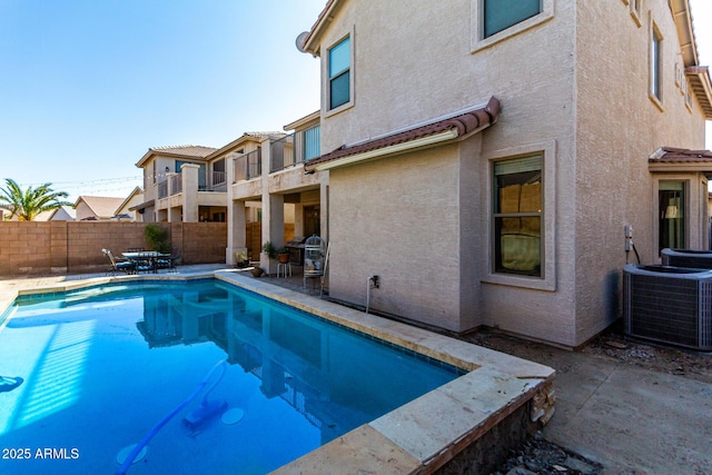 view of pool featuring a patio and central AC unit