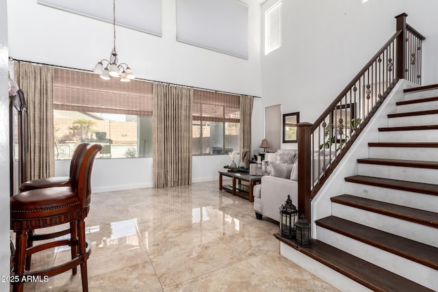 interior space with an inviting chandelier and a high ceiling