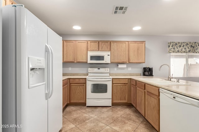 kitchen featuring light tile patterned floors, light countertops, visible vents, a sink, and white appliances