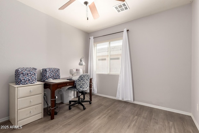 office featuring visible vents, ceiling fan, baseboards, and wood finished floors