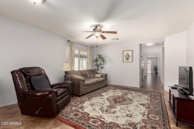 living area with ceiling fan, visible vents, and baseboards