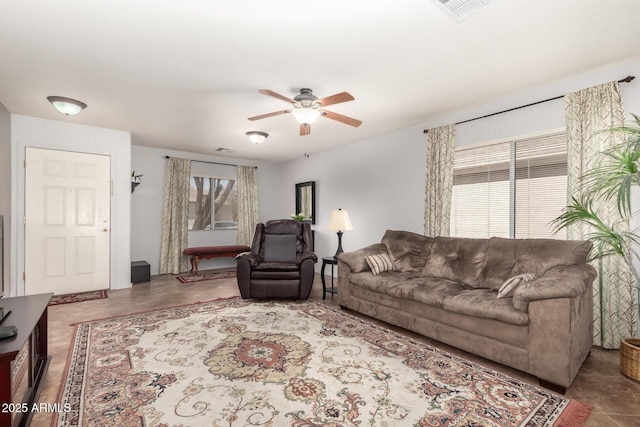 living room featuring ceiling fan and visible vents