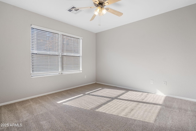 unfurnished room with ceiling fan and carpet