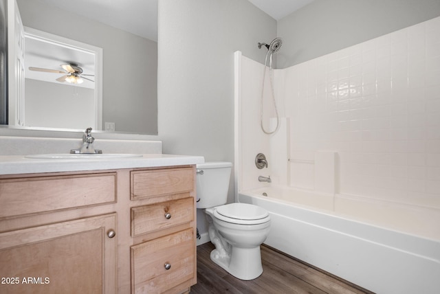 full bathroom featuring toilet, shower / bath combination, ceiling fan, wood-type flooring, and vanity