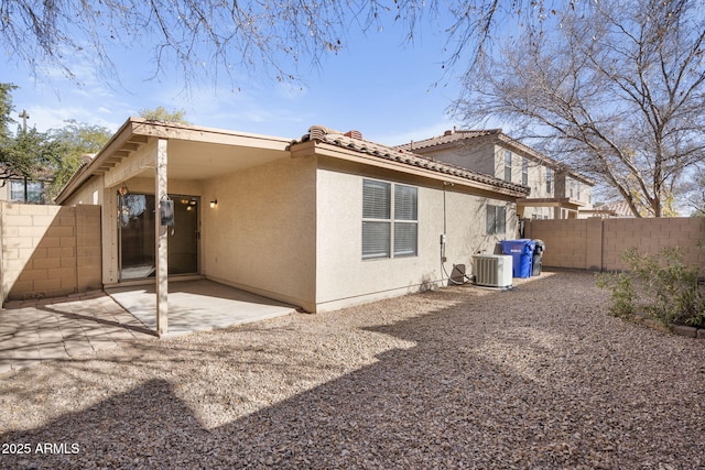 back of property featuring cooling unit and a patio area