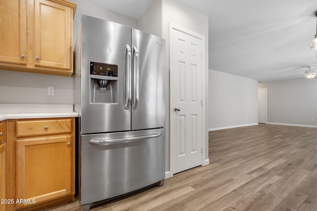 kitchen featuring stainless steel fridge with ice dispenser, ceiling fan, and light hardwood / wood-style flooring