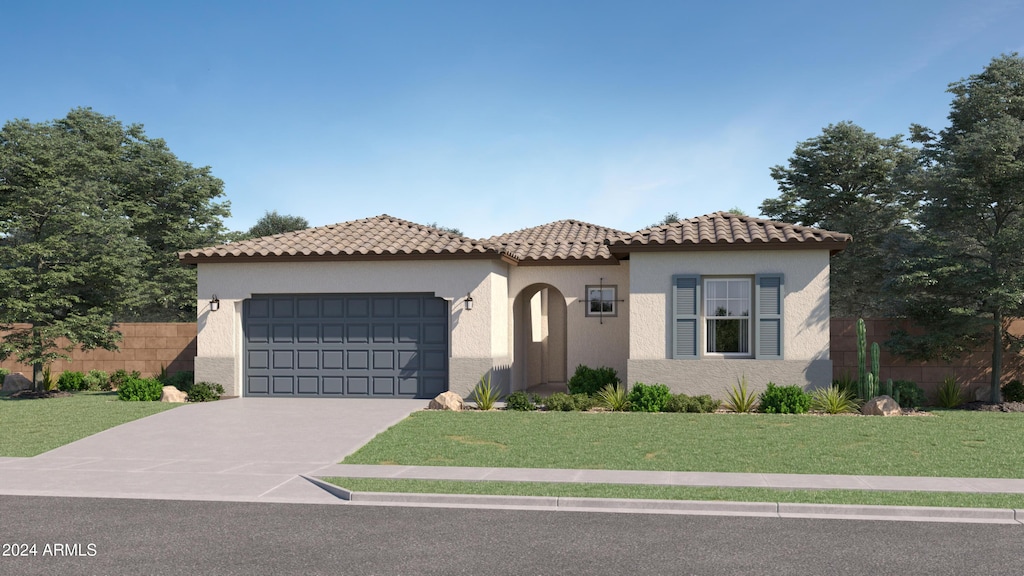 mediterranean / spanish house featuring a garage and a front lawn