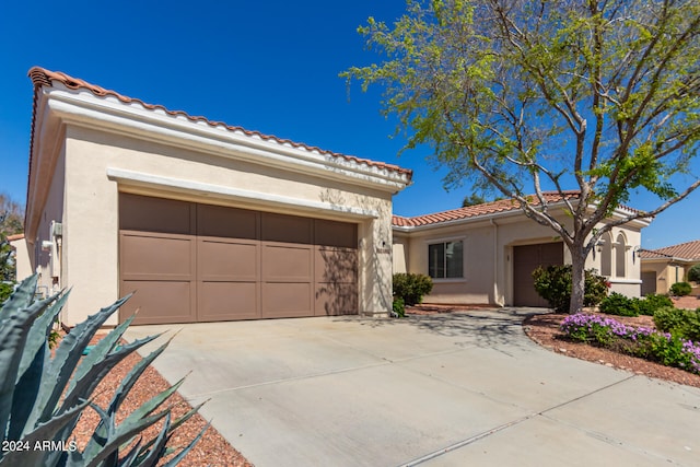 mediterranean / spanish-style home with a garage