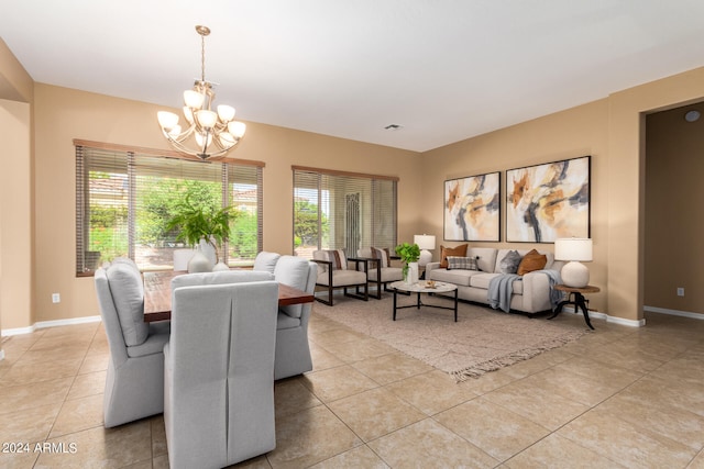 tiled dining space featuring an inviting chandelier and plenty of natural light