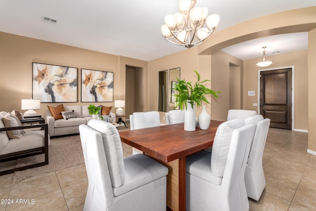 dining room featuring a chandelier and light tile patterned flooring