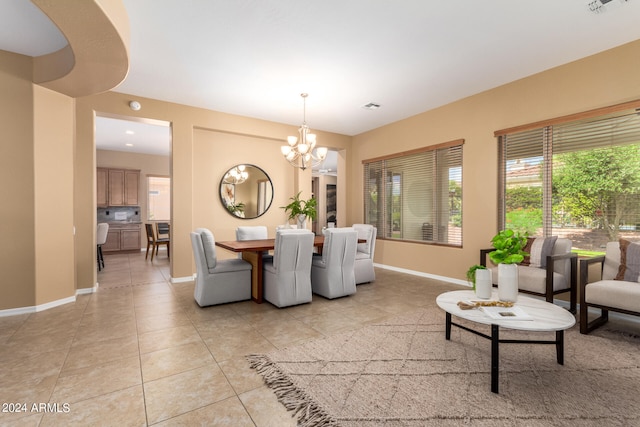 tiled living room featuring a notable chandelier