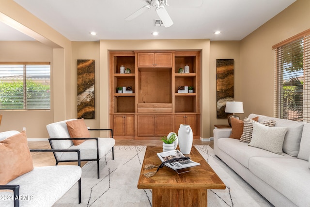 living room with ceiling fan and plenty of natural light