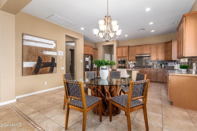 tiled dining space featuring an inviting chandelier