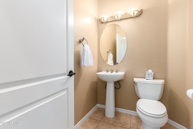 bathroom with toilet and tile patterned floors