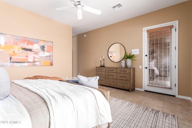 tiled bedroom featuring ceiling fan and access to exterior