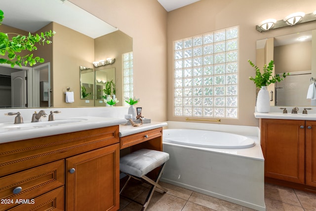 bathroom featuring tile patterned floors, independent shower and bath, and vanity