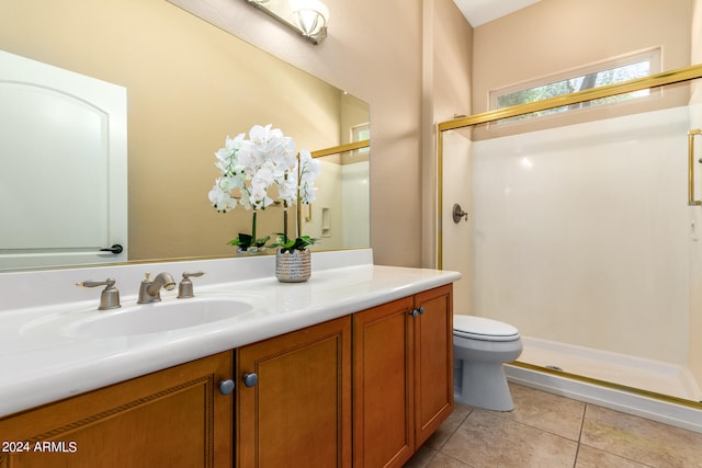 bathroom featuring vanity, a shower with shower door, toilet, and tile patterned flooring