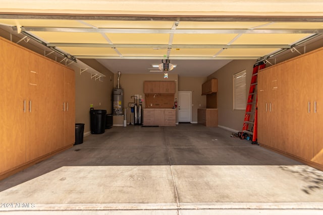 garage with water heater and a garage door opener