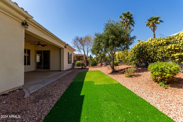 view of yard featuring a patio and ceiling fan