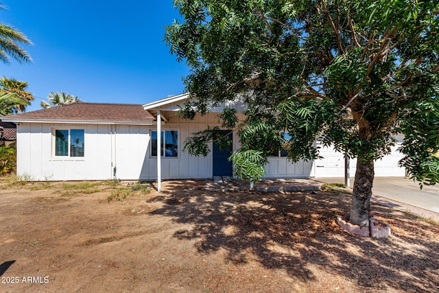 13039 N 19th Ave, Phoenix, AZ 85029 - view of front of house with board and batten siding, concrete driveway, and a shingled roof