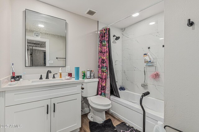 13039 N 19th Ave, Phoenix, AZ 85029 - full bathroom featuring wood finished floors, shower / bath combo with shower curtain, vanity, and toilet