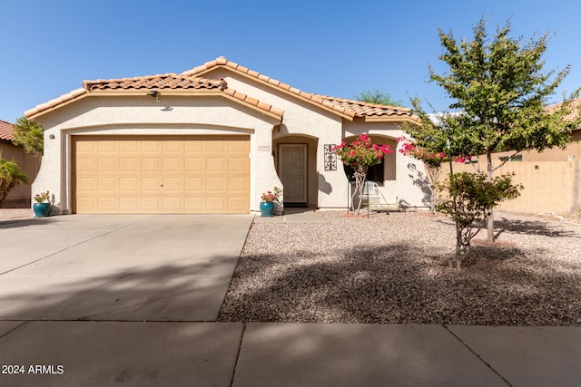 mediterranean / spanish-style home featuring a garage