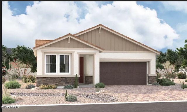 5018 W Hardtack Trl, Laveen, AZ 85339 - view of front of home with stone siding, an attached garage, decorative driveway, stucco siding, and board and batten siding