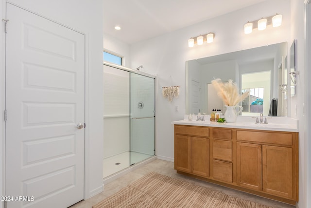 bathroom featuring vanity, an enclosed shower, and tile patterned floors